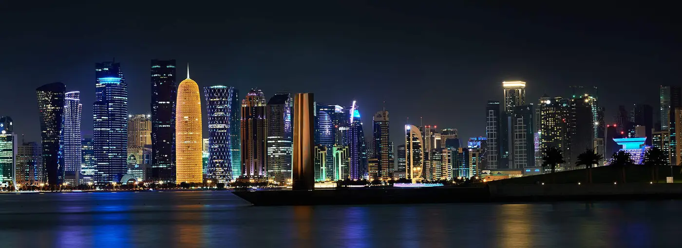 The Doha skyline across the bay at dusk